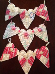 some heart shaped ornaments are hanging on a table