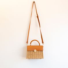 NOW AVAILABLE IN STOCK. FAST SHIPPING FROM LOS ANGELES. 3-5 DAYS This exquisite Elena Handbags Straw Woven Box Bag featuring a leather flap and trims is a sophisticated addition to any wardrobe. Crafted from natural straw material, its classic style is further enhanced with leather accents for a timelessly elegant look. Perfect for formal occasions or everyday wear. Material: Straw + PU Leather Size: 21cm wide x 24cm tall (8in x 9in) Designer Style ID: 8283 Rectangular Natural Straw Bag With Detachable Strap, Travel Rectangular Straw Bag With Detachable Strap, Natural Rectangular Straw Bag With Detachable Strap, Rectangular Box Bag With Braided Handles For Travel, Rectangular Travel Box Bag With Braided Handles, Square Straw Bag With Detachable Strap For Travel, Brown Square Straw Bag With Detachable Handle, Beige Square Straw Bag With Detachable Strap, Beige Rectangular Straw Bag With Detachable Strap