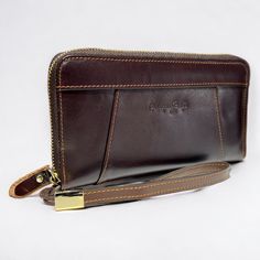 The Genuine Leather wallet Phone Bag Long Retro wallet is a stylish and practical accessory for the modern individual.  It is made from high-quality genuine leather that offers durability and a premium feel.  The wallet features multiple card slots and a spacious main compartment to store your phone and other essentials.  The long and Zipper design makes it easy to carry in your pocket, while the retro look adds a touch of vintage charm to your everyday look.  Whether you're running errands or h Formal Brown Wallet With Zipper Pouch, Business Clutch Wallet With Zipper Pouch, Business Wallets With Zipper Closure, Business Wallets With Zipper Closure In Rectangular Shape, Business Clutch Wallet With Coin Pocket, Classic Rectangular Wallets With Zipper Pocket, Rectangular Business Wallets With Zipper Closure, Modern Brown Clutch Wallet, Leather Bifold Bag With Zipper Pouch