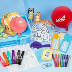 an assortment of children's art supplies including markers, pens, and balloons on a blue background