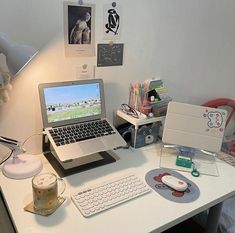 a laptop computer sitting on top of a white desk