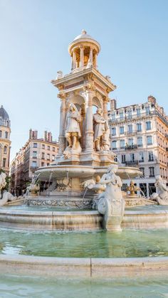 a fountain in the middle of a city square