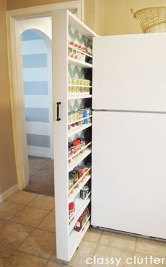 an open refrigerator in a kitchen next to a pantry