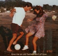 a man and woman kicking a soccer ball on the beach with an inspirational quote about love