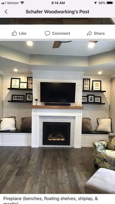 a living room with fireplace, couches, and pictures on the wall above it