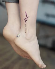 two small tattoos on the feet of people's legs, one with a flower