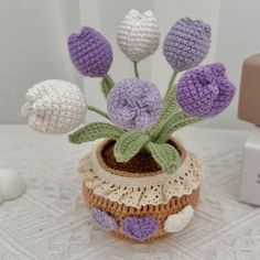 crocheted flowers in a pot on a table