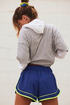 A twist on a sporty classic, these quick-drying shorts feature bold piping details and embroidery to elevate your run. **Fit:** Pull-on style mid-rise shorts; fitted waist and relaxed bottom **Features:** Durable ripstop, water resistant outer fabric with subtle crinkle texture; quick-drying built-in brief; welt pocket to fit cards or keys **Why We ❤ It:** These shorts offer easy comfort and feature hard-working materials that keep you comfortable when you’re out in the elements. | Varsity Blues Tennis Fits, Colorful Activewear, Varsity Blues, Branding 101, Free People Activewear, Athletic Clothes, Sport Top, Mid Rise Shorts, Active Wear Shorts