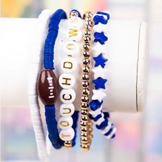 three bracelets with football charms on them are stacked in the shape of stars and beads