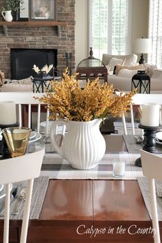 Fall table setting with white pitcher and golden stem centerpiece. Neutral Kitchen Table, Neutral Fall Aesthetic, Neutral Family Room, Neutral Fall Decor Ideas, Fall Kitchen Table, Rustic Stone Fireplace, Fall Dining Room Table, Dining Room Table Settings, Cozy Inspiration