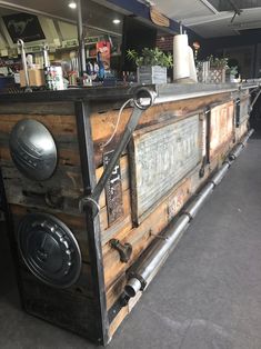 an old wooden bar with metal pipes and knobs on the front, in a restaurant