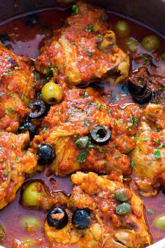 chicken with olives and sauce in a pan