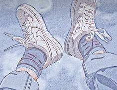 the bottom view of someone's feet wearing blue jeans and white sneakers with clouds in the background