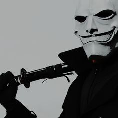 a man wearing a white mask and holding a knife