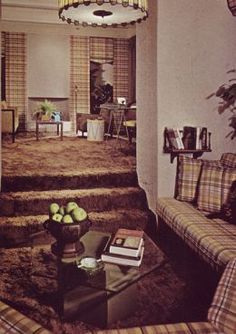 a living room filled with furniture and a chandelier hanging over the top of it