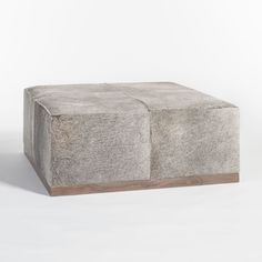 a concrete block sitting on top of a white floor