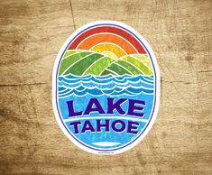 a lake tahoe sticker on a wooden surface