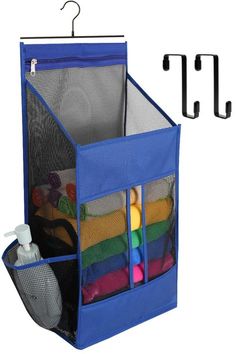 a blue hanging storage bag filled with lots of toys and other items next to hooks