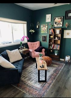 a living room filled with furniture and a rug on top of a hard wood floor