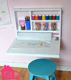 a child's desk and stool in a play room