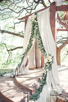 the wedding arch is decorated with flowers and greenery