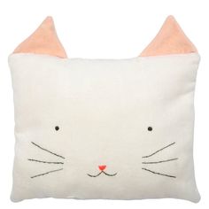 a white pillow with a cat face on it