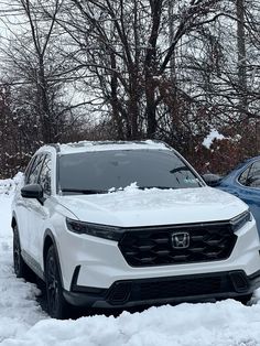 two cars parked in the snow next to each other