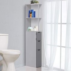 a white toilet sitting next to a tall shelf filled with bathroom items on top of it