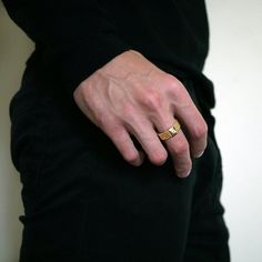 a man wearing a gold wedding ring on his left hand