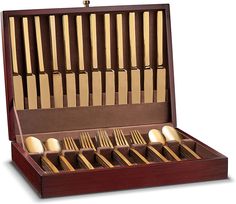 a wooden box filled with lots of gold colored spoons and fork's in it