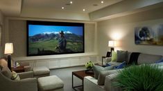 a living room filled with furniture and a flat screen tv mounted to the side of a wall