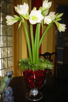 white flowers in a glass vase on a table