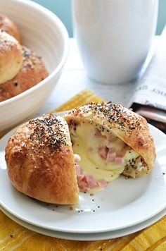 a ham and cheese roll on a white plate