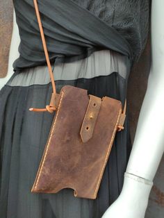 a woman's dress with a brown leather purse attached to it