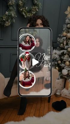 a woman sitting on a couch in front of a christmas tree holding a sign that says beautiful