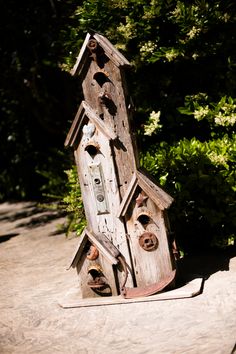 a bird house made out of old wooden boards