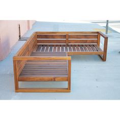 a wooden bench sitting on top of a sidewalk