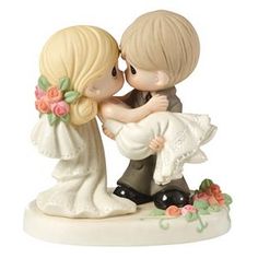 a figurine of a bride and groom kissing each other on their wedding day