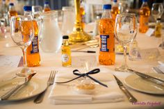 a table is set with empty wine bottles and silverware, utensils and napkins