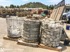 two large bags of cement sitting on top of a pallet in a parking lot