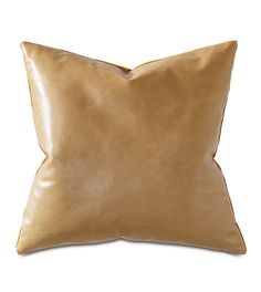 a tan leather pillow on a white background