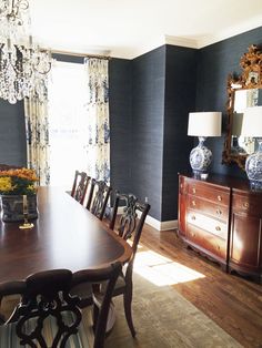 a dining room table with chairs and a chandelier