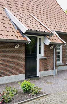 a brick house with a black door and windows