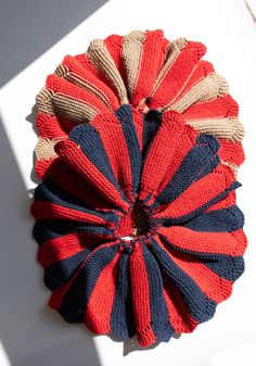 a red, white and blue knitted object sitting on top of a table