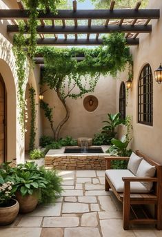 an outdoor patio with stone flooring and potted plants on either side of it