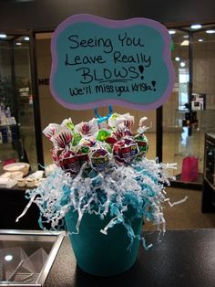 a vase filled with candy and candies sitting on top of a table next to a sign that says seeing you leave really bliss