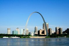 the st louis skyline is seen from across the water in front of the gateway arch