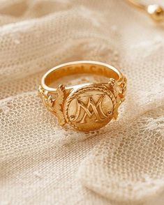 a gold ring sitting on top of a white cloth