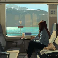 a woman is sitting on a train looking out the window at the ocean and mountains