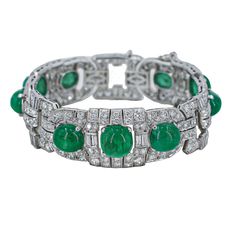 A fantastic Art Deco style bracelet featuring round brilliant cut diamonds and emerald cabs. This bracelet is finely crafted in 18k white gold, featuring a diamond total carat weight of 15.00 carats. The 9 emeralds measure to 36.00 carats. Details- 18k White Gold Cut: Round Brilliant Cut Diamond total carat weight: 15.00cts Additional Gemstone Details: Featuring 9 Emerald Cabs Total Cab carat weight: 36.00cts This stunning Art Deco Diamond and Emerald Cab Bracelet is only available at Burdeen's Black Diamond Bands, Diamond Bracelet Design, Jewellery Indian, Emerald Bracelet, Art Deco Bracelet, Sparkly Jewelry, Jewelry Post, Royal Jewels, Green Gems